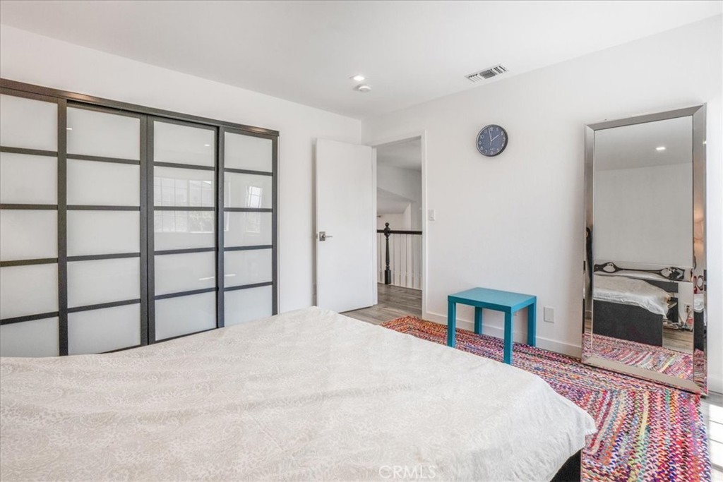 Primary bedroom with frosted glass closet doors
