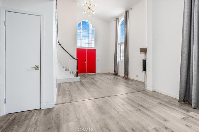 Entry foyer with red double doors and arched window