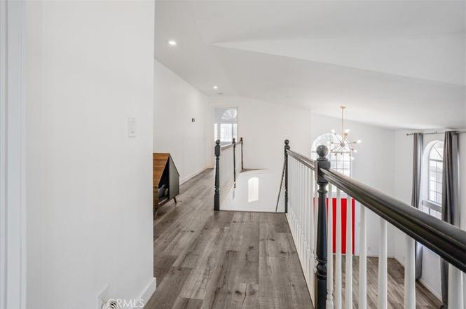 Upper hallway looking down to curved staircase